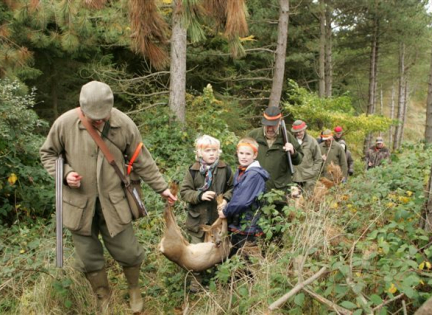 Jægere og børn bærer vildtet ud. Foto: Niels Frost, Jægerforbundet.